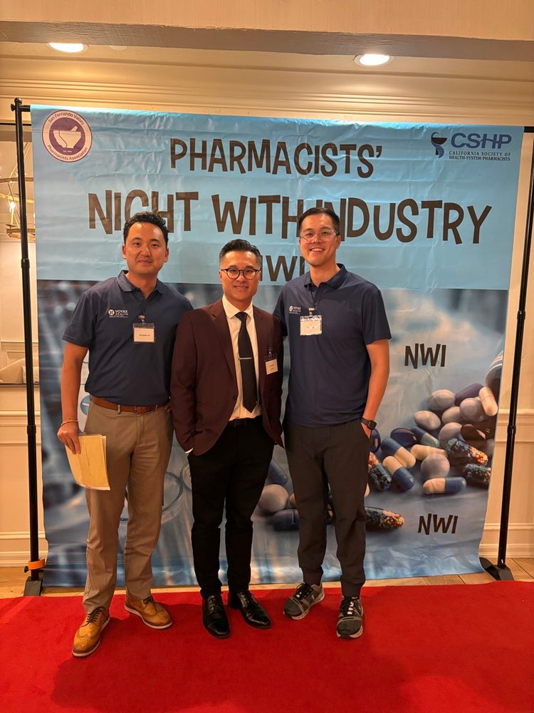 Voyax Health team members in front of the Pharmacists' Night with Industry banner